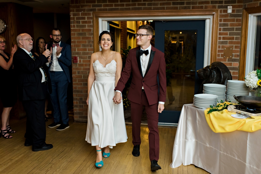 A newly married couple walk into their reception at society hill dance academy in Philadelphia.